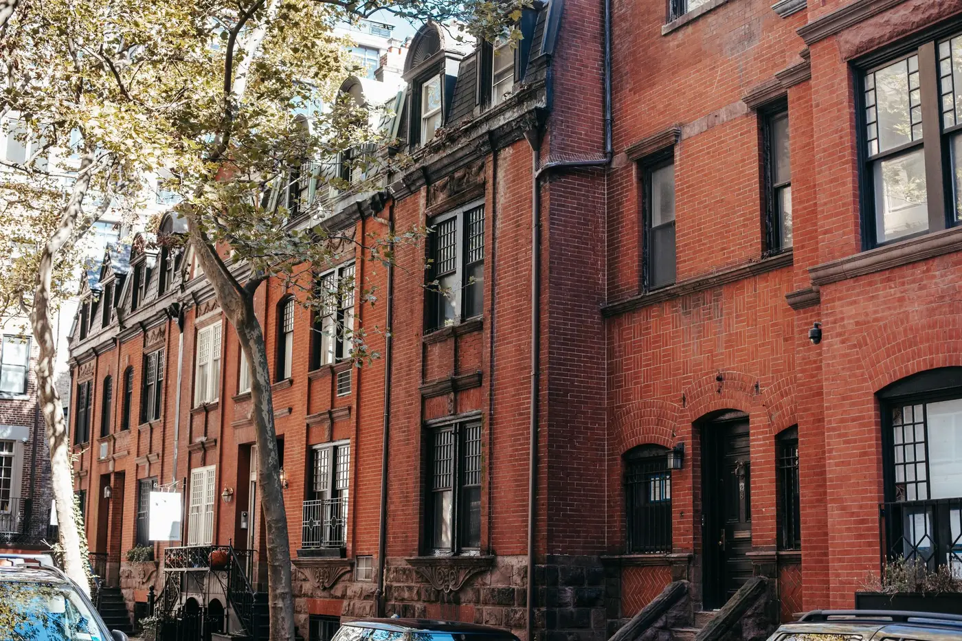 A row of brick townhouses on a residential city street